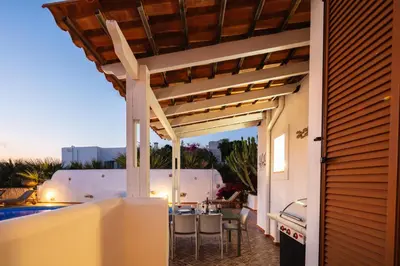 an outdoor patio with a pergola and a table at Villa Aliki ,Aegean Sea Breeze 750m from the Beach! in Chania Town