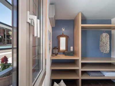 a dressing room with a mirror and a window at The House By The Sea in Kato Daratso
