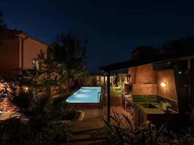 a swimming pool in a yard at night at The House By The Sea in Kato Daratso