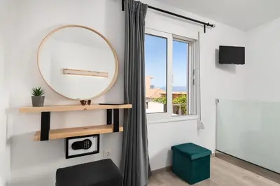 a mirror in a room with a window at 