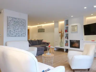 a living room with white chairs and a couch at Villa Belle Helene Kalamaki Chania in Kalamaki Chanion