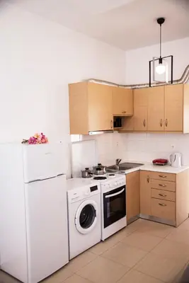 a kitchen with a washing machine and a washer at Nikis Apartment 2 in Chania Town