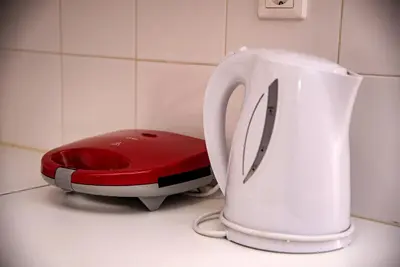 a white and red toaster sitting on top of a counter at Nikis Apartment 2 in Chania Town