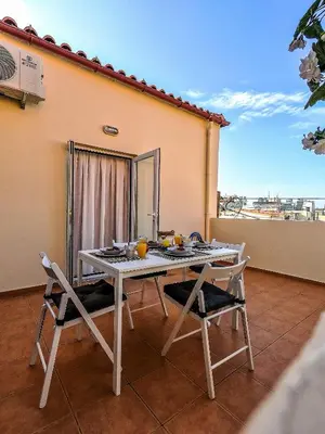 a white table and two chairs on a balcony at Nikis Apartment 2 in Chania Town