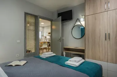 a bedroom with a bed with towels on it at JT Apartments in Kissamos