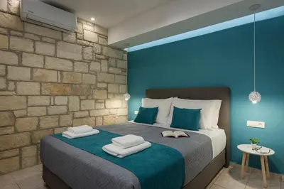 a bedroom with a large bed with towels on it at JT Apartments in Kissamos