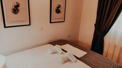 a room with a bed with two towels on it at Nikis Apartment 3 in Chania Town