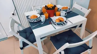 a white table with plates of food on it at Nikis Apartment 3 in Chania Town