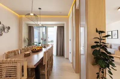 a dining room and kitchen with a long table and chairs at Villa Aroma in Chania Town