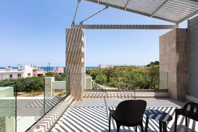 a balcony with chairs and a view of the ocean at Villa Aroma in Chania Town