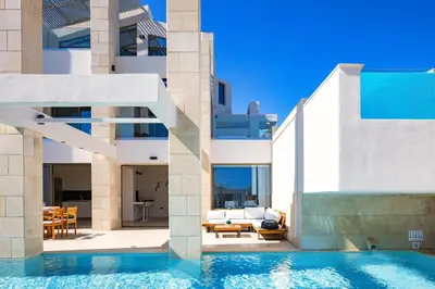 a house with a swimming pool next to a building at Villa Aroma in Chania Town