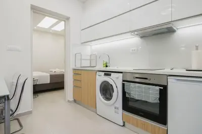 a kitchen with a washer and a washing machine at Peris 3 - Central Apt near Old Town - AC, Wifi in Chania Town