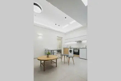 a living room with a table and a kitchen at Peris 3 - Central Apt near Old Town - AC, Wifi in Chania Town