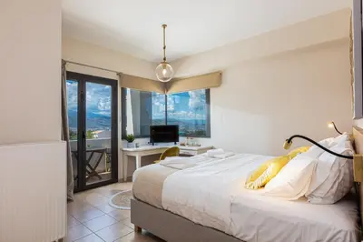 a bedroom with a bed and a desk with a computer at Artemisia Residence in Chania Town