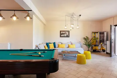 a living room with a pool table and a couch at Villa Golden Hill in Chania Town