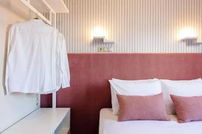 a bedroom with a bed and a robe hanging on a wall at Villa Golden Hill in Chania Town