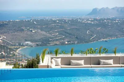 a pool with a view of the ocean and a villa at Villa Golden Hill in Chania Town