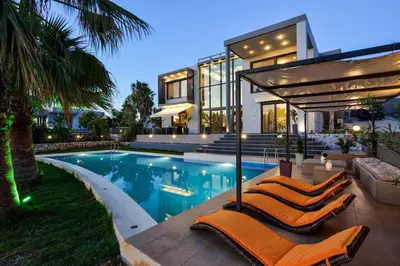 a home with a swimming pool and a house at Adorno Luxury Villa in Chorafakia