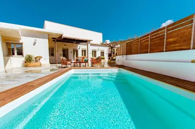 a swimming pool in the backyard of a house at Chania Paradise Retreat - Falasarna Villa Nostalgia in Plátanos
