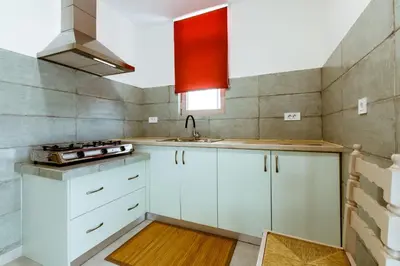 a kitchen with white cabinets and a sink at Chania Paradise Retreat - Falasarna Villa Nostalgia in Plátanos