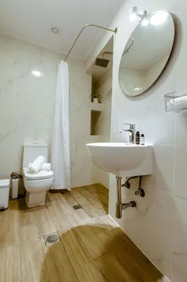 a bathroom with a sink and a toilet and a mirror at Chania Paradise Retreat - Falasarna Villa Nostalgia in Plátanos