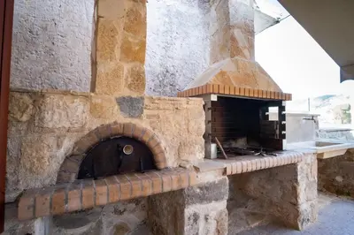 an outdoor pizza oven in a stone building at Villa Styliani in Kissamos
