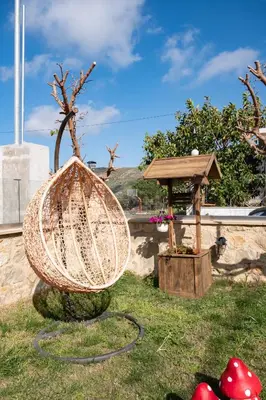 a garden with a basket and a bird house at Villa Styliani in Kissamos