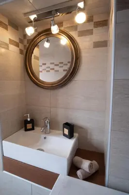 a bathroom with a white sink and a mirror at Villa Styliani in Kissamos