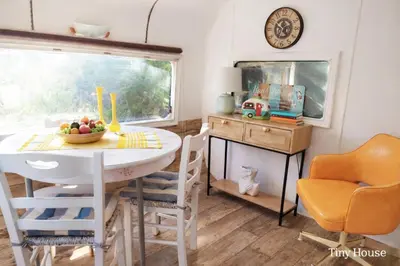 a dining room with a table and chairs and a window at dream tiny house & luxury tent, 6 km from center Chania in Chania Town