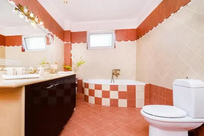 a bathroom with a tub and a toilet and a sink at Andronikis House in Pithárion