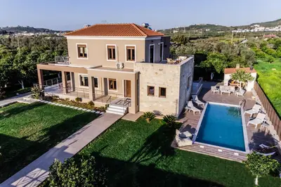 an aerial view of a house with a swimming pool at Villa Pervoli in Varípetron