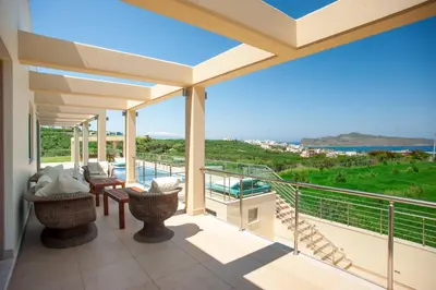 a balcony with a view of the ocean at Luxury 6-Bedroom Villa With Private Pool- Villa Prigipessa in Chania Town