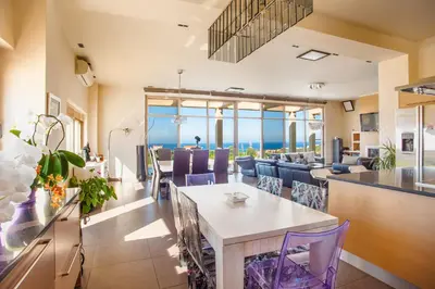 a living room with a table and chairs at Luxury 6-Bedroom Villa With Private Pool- Villa Prigipessa in Chania Town