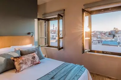a bedroom with a bed with a view of a city at House 8 - In the Heart of Venetian town w. Parking in Chania Town