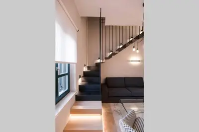 a living room with a couch and stairs at House 8 - In the Heart of Venetian town w. Parking in Chania Town