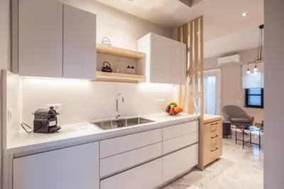 a kitchen with white cabinets and a sink at House 8 - In the Heart of Venetian town w. Parking in Chania Town