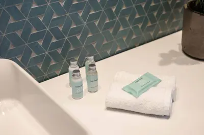 a bathroom with two bottles of soap on a sink at House 8 - In the Heart of Venetian town w. Parking in Chania Town