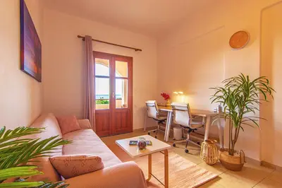 a living room with a couch and a table at Liviko Beach Apartments - only adults in Frangokastello