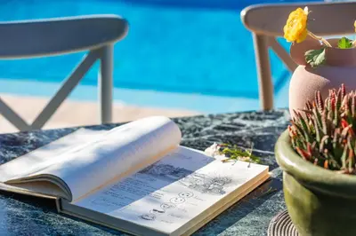 a book on a table next to a vase at Villa Nikis in Chania Town