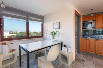 a kitchen with a table and chairs and a window at Villa Nikis in Chania Town