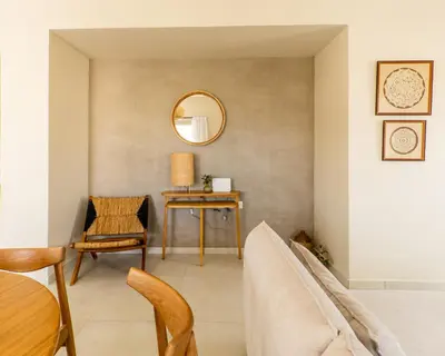 a living room with a table and a mirror at Villa Oliveto in Tavronitis