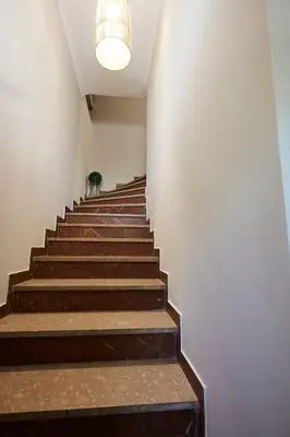 a staircase in a building with a light fixture at Chrissula apt Homeleader in Chania Town