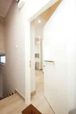 a hallway with a white door in a room at Chrissula apt Homeleader in Chania Town