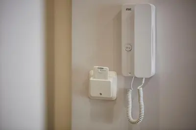 a white phone is hanging on a wall at Chrissula apt Homeleader in Chania Town