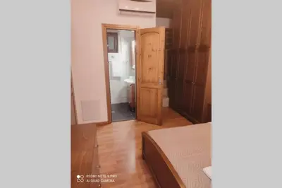 a bedroom with a bed and a door to a bathroom at Georgia's Village House in Kaláthenai
