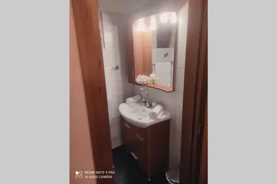 a bathroom with a sink and a mirror at Georgia's Village House in Kaláthenai