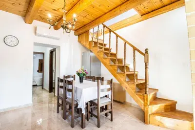 a dining room with a table and wooden stairs at Platania's Paradise in Chania Town
