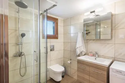 a bathroom with a shower and a toilet and a sink at Platania's Paradise in Chania Town