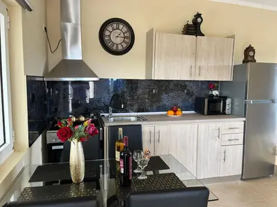 a kitchen with a stove and a clock on the wall at Chrispa's House in Chania Town