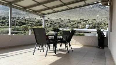 a table and chairs on a balcony with a view at Chrispa's House in Chania Town